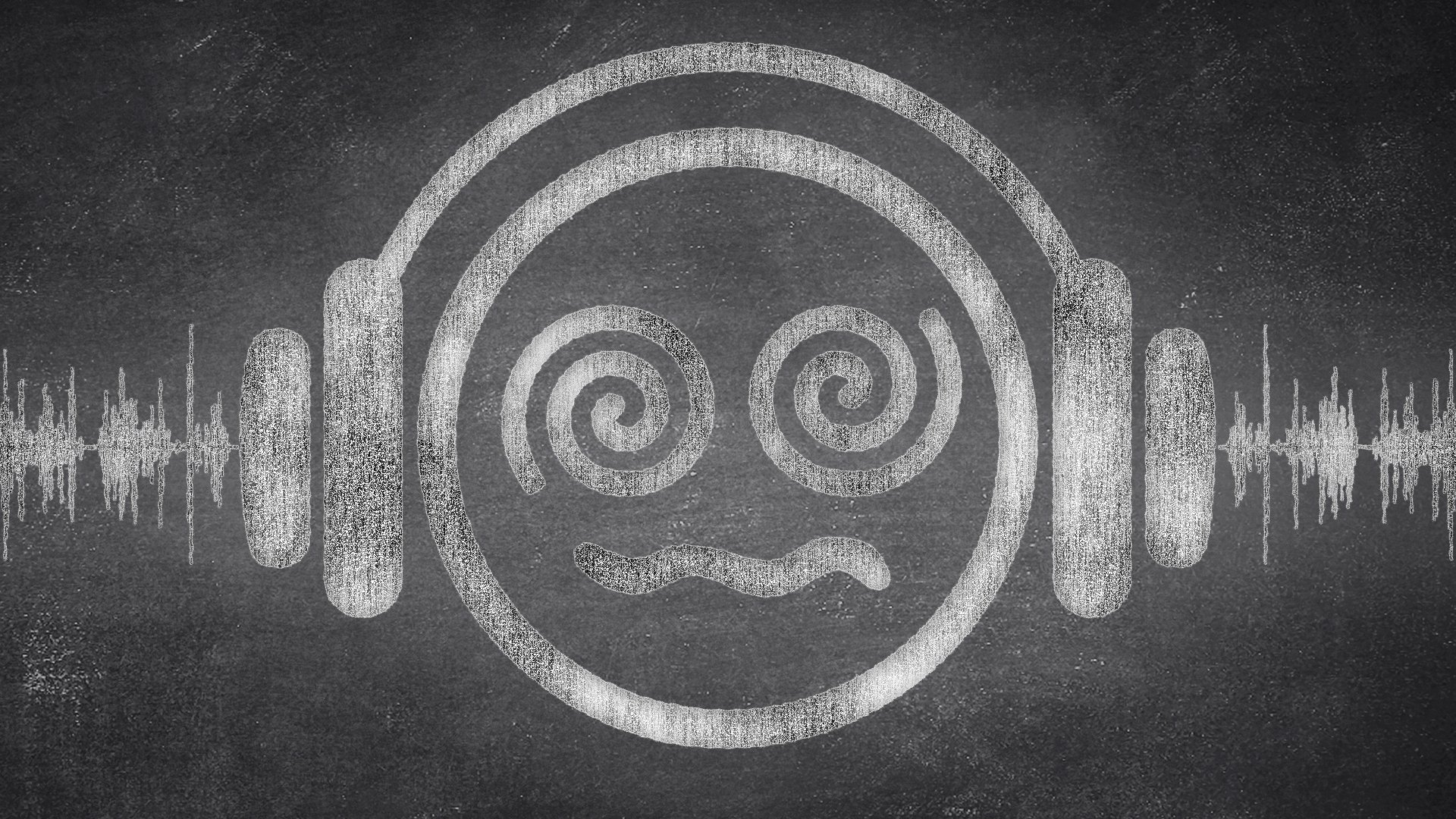 image of spiral eys emoji face in white chalk on a blackboard