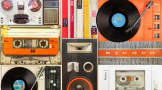 A collection of classic audio formats and players, like turntables and cassette decks, representing the 'sound of nostalgia'.