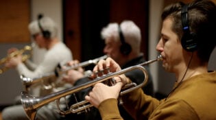 Live music session for New Orleans Pelicans sonic brand theme, three male musicians playing trumpets.