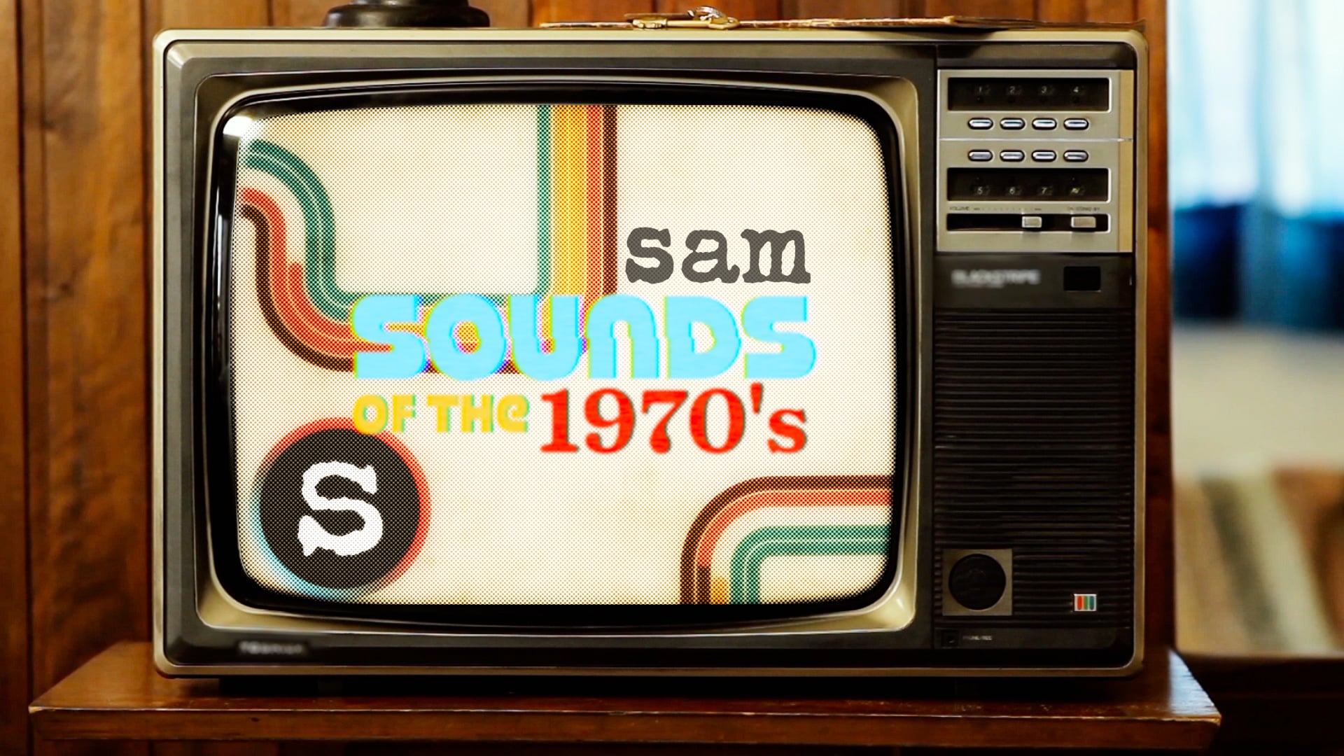 Vintage retro television screen displaying colorful 1970s rainbow stripes and text reading "SAM Sounds of the 1970's".